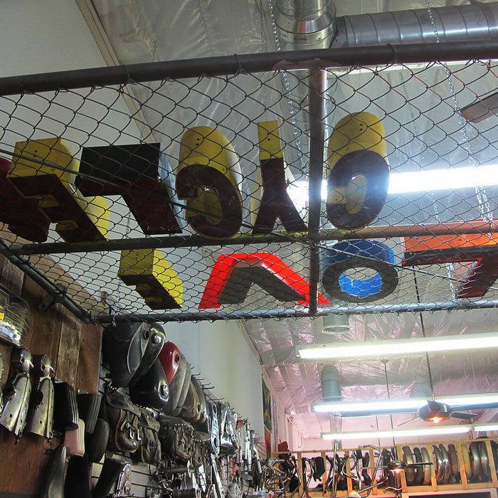 A photo of red, orange, yellow, and blue letters writing "Love Cycles"