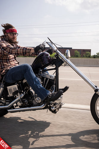 Andrew Gassman riding his bike, The Midnight Witch, down the highway