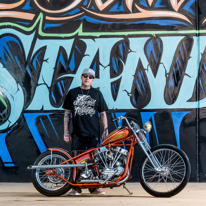 Motorcycle artist with orange motorcycle