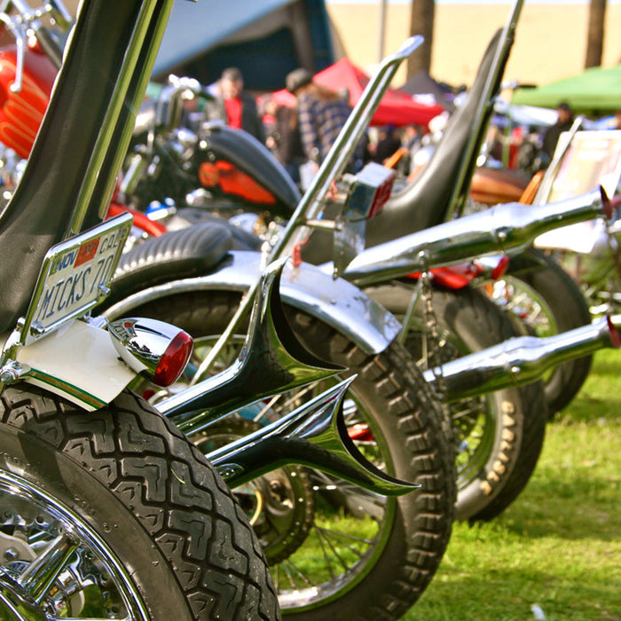 A photo of a line of fenders of bikes parked at David Mann Chopperfest. 