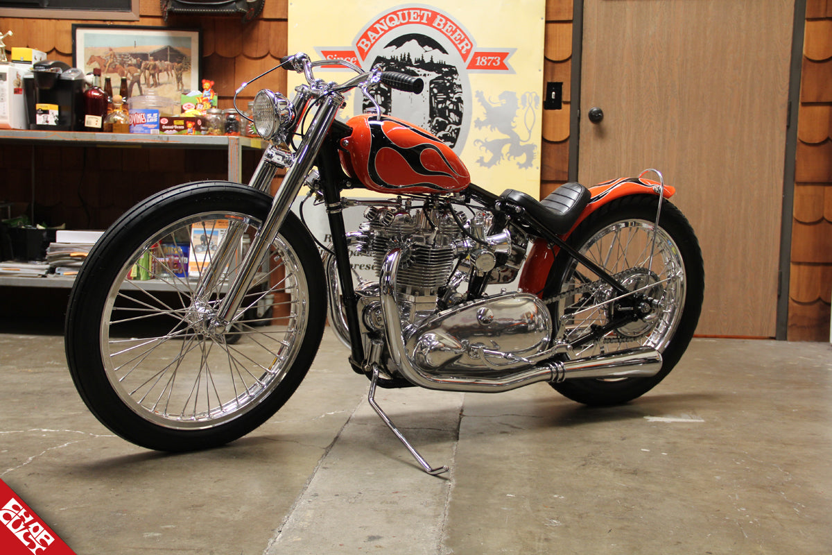 A side view of the orange bike with a black flame pattern that is discussed in this post