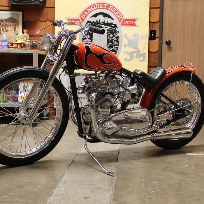 A side view of the orange bike with a black flame pattern that is discussed in this post