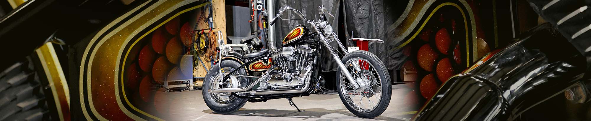 sportster chopper build by throttle addiction on close up background of oil tank with custom paint