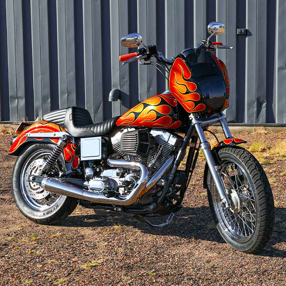 dyna motorcycle in front of garage doors