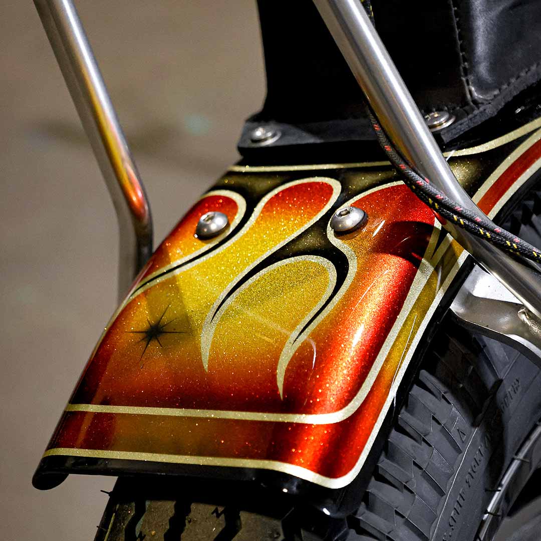 close up detail of a trailer fender on a motorcycle with 1970s style chopper paint